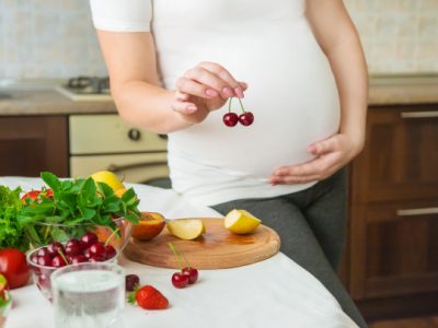 pregnant-woman-eats-vegetables-fruits_73944-13863